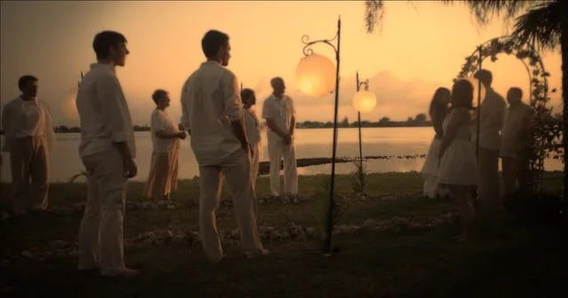 Still from "The Perfect Wedding" - Alaina's sunset Christmas Eve wedding, everyone dressed in white
