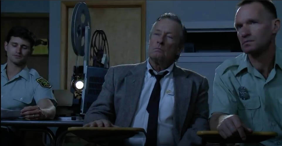 Still from "Caught" - Cops reviewing footage from sting operation