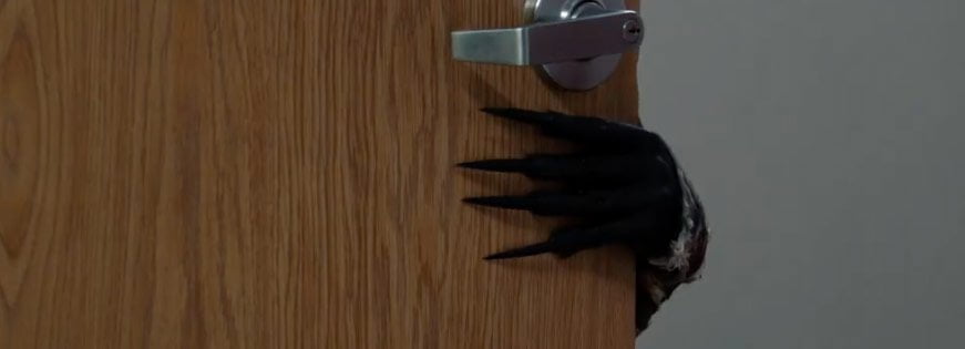 Screen from "The Quiet Room" - Demon Hattie's hand is reaching around the hospital door...