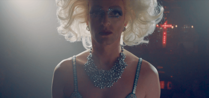 Your Eyes On Me 1 Still from "Your Eyes On Me" - close up on Gloria (Paul Stone), in drag, backlit on stage