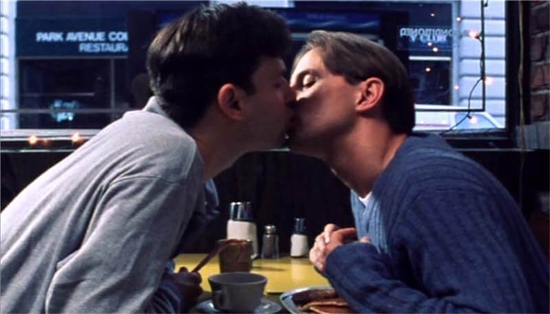 Still from “24 Nights” - Keith and Jonathan share a kiss from across the diner booth