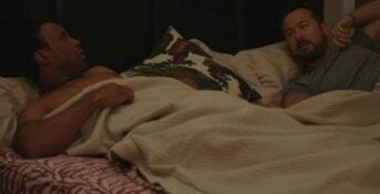 Still from "Red Lodge" - Jordan and Dave climb into bed, but things are icy between them