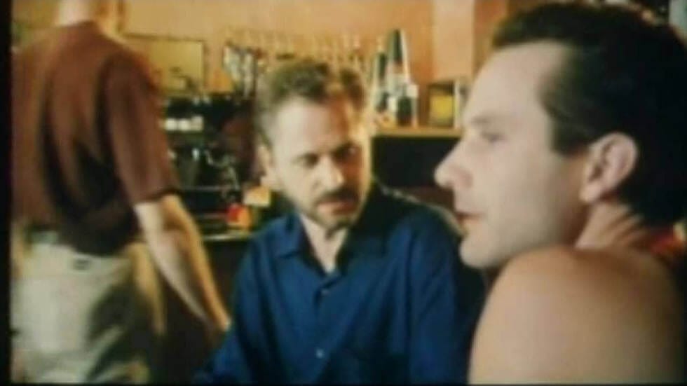Still from "Coffee Date" short film - Kelly and Todd chat while waiting for their mystery dates at a cafe